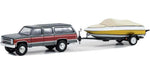 Greenlight ‘87 Chevrolet Suburban K20 Silverado With Boat & Trailer 1:64.